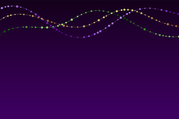 Mardi gras traditional necklaces on a dark purple background. © Anna R