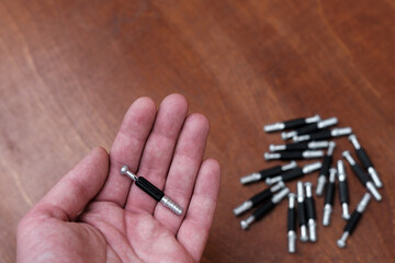 The furniture fixing screw is in the palm of your hand.