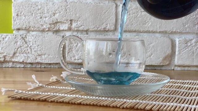 Crystal cup with green tea on table