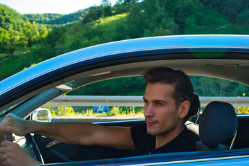 A handsome and cool man driving a car