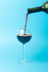 Wine is poured into a glass. Red wine is poured into a glass for tasting, minimal concept