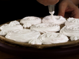 making meringue cakes. egg white meringue. pastry shop. sweet