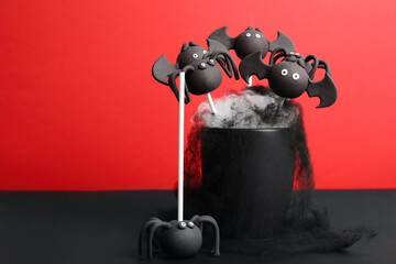 Delicious Halloween themed cake pops on red background