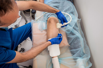 Cardiologist use tubes and ultrasound for radiofrequency catheter ablation.