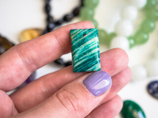 Natural amazonite pendants in a woman's hand