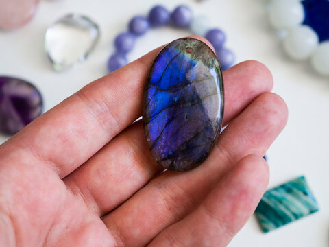 Labradorite pendant in a woman's hand