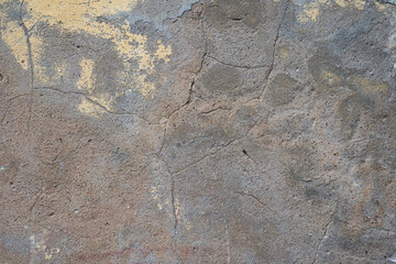 Old concrete wall. Concrete surface with cracks. Grey construction background. A pattern of cracks on an old wall.