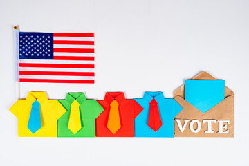 Voting in the us presidential election. A row of origami men next to the Bulletin and the American flag. A polling station in new York. The USA presidential election in 2020.