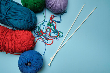 Group of various yarn balls and knitting needles closeup