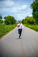 Obraz premium Young asian / Indian boy running on the road