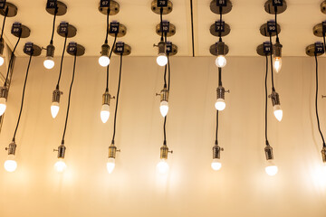 Decorative lamps hang from the ceiling against the backdrop of the wall, glowing with soft light.