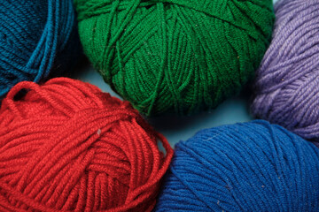 Group of various yarn balls and knitting needles closeup