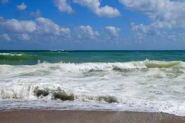 big white waves hitting the sea shore