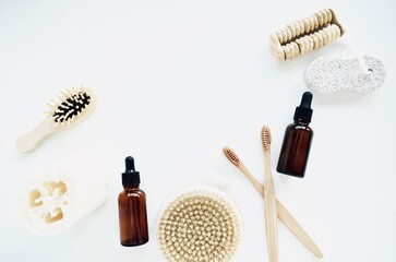 Zero waste of bathroom accessories, natural brush, wooden comb, oil, makeup remover in a glass container. lifestyle concept, flat lay.