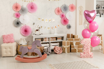 Birthday decorations - gifts, toys, balloons, garland and figure for little baby party on a white...