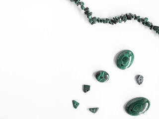 Natural malachites of different sizes on a white background