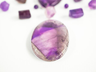 Natural amethyst of different sizes on a white background