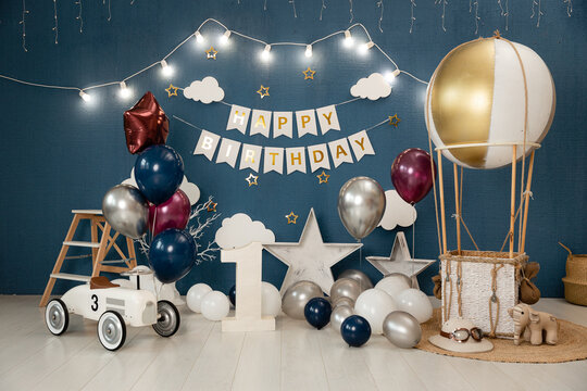 Birthday Decorations - Gifts, Toys, Balloons, Garland And Figure For Little Baby Party On A Blue Wall Background.