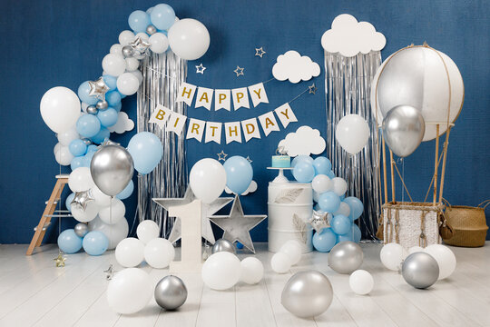 Birthday Decorations - Gifts, Toys, Balloons, Garland And Figure For Little Baby Party On A Blue Wall Background.