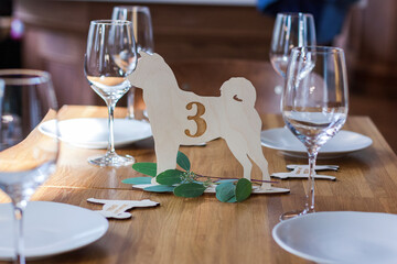 Wooden number on the table with the number three is on the table in the restaurant
