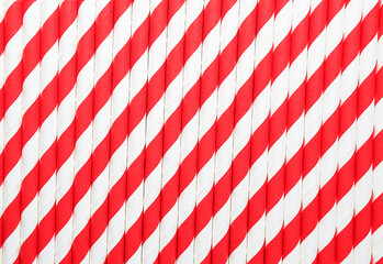 Fototapeta premium Abstract background of red and white colored paper striped cocktail straws.