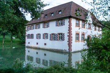 Fototapeta na wymiar Water castle with moat in Inzlingen