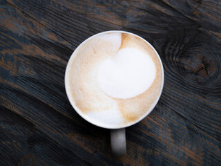 Cappuccino in a mug on a wooden table