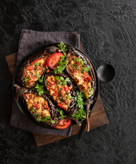 Karniyarik. Stuffed eggplant, eggplant with meat and vegetables, baked with tomato sauce, Turkish cuisine. Top view, close-up