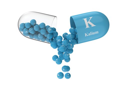 Open capsule with kalium from which the vitamin composition is pouring