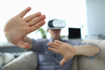 Man in virtual gaming glasses gestures with his hands. Immersion in virtual reality concept