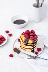 Tasty Pancakes. Stack of pancakes topped with chocolate and raspberry. Breakfast