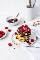 Tasty Pancakes. Stack of pancakes topped with chocolate and raspberry. Breakfast