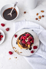 Tasty Pancakes. Stack of pancakes topped with chocolate and raspberry. Breakfast