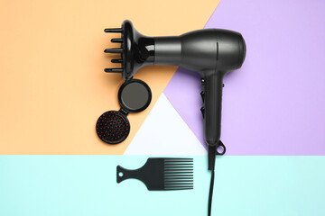 Fototapeta na wymiar Hair dryer and different brushes on color background, flat lay. Professional hairdresser tool
