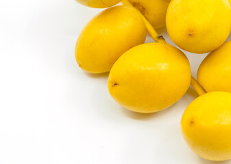 Macro organic fresh Date Palm fruit or Date fruit on white background. Date Palm fruit is on corner of art board frame.