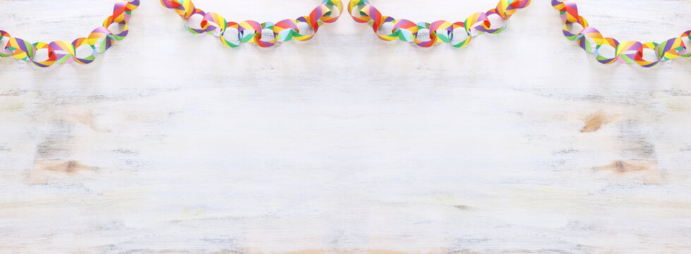 Paper Colorful Chain Garland Over White Wooden Background. Traditional Jewish Sukkot Holiday Decoration