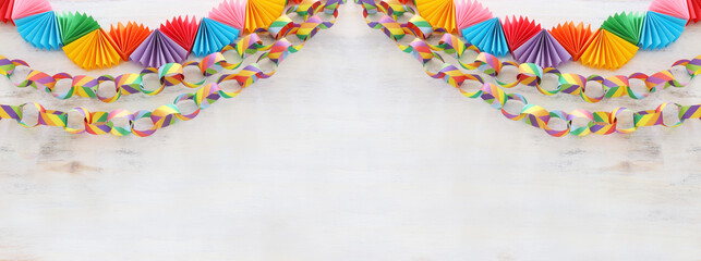 Paper colorful chain garland over white wooden background. Traditional jewish sukkot holiday...