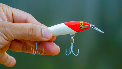 fishing lure held in hand,a fishing lure is a type of artificial fishing bait used to attract fish....