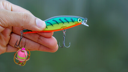 fishing lure held in hand,a fishing lure is a type of artificial fishing bait used to attract fish. Lures come in many different shapes, sizes, and colors, each designed to attract fish