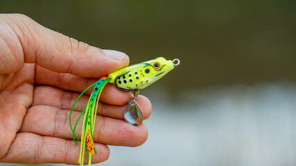 fishing lure held in hand,a fishing lure is a type of artificial fishing bait used to attract fish. Lures come in many different shapes, sizes, and colors, each designed to attract fish