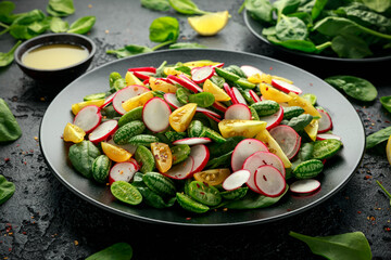Cucamelon salad with radish, tomato, spinach and mustard dressing. Healthy food.