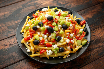 Loaded potato Vegan Fries with tomato, cucumber, olives and feta cheese