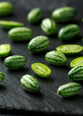 Fresh green Cucamelon on rustic stone board