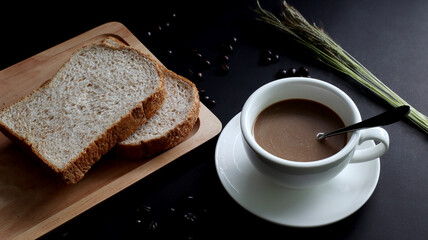 Hot coffee in a white cup Coffee beans, roasted, black background