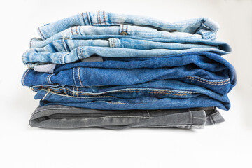 pile of stack of blue jeans jeans isolated on white background. Jeans pants