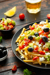 Loaded potato Vegan Fries with tomato, cucumber, olives and feta cheese