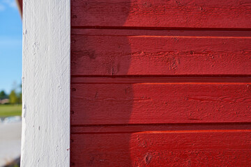 A red painted wooden wall of a building as a background. Copy space.