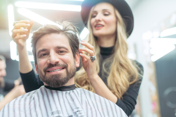 Man consulting woman hair stylist for advise on cut and styling