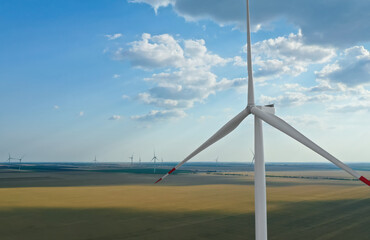 Modern windmill in field, space for text. Energy efficiency