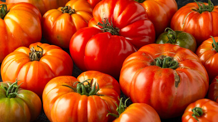 Ripe Beefsteak Tomatoes on rustic black table